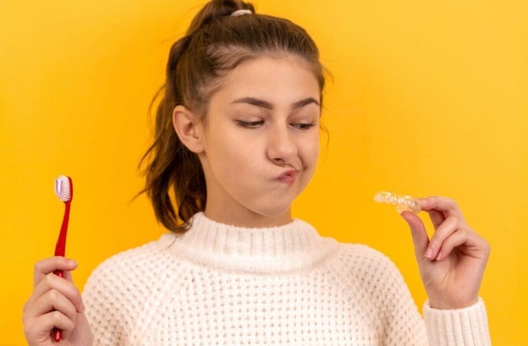 woman holding toothbrush