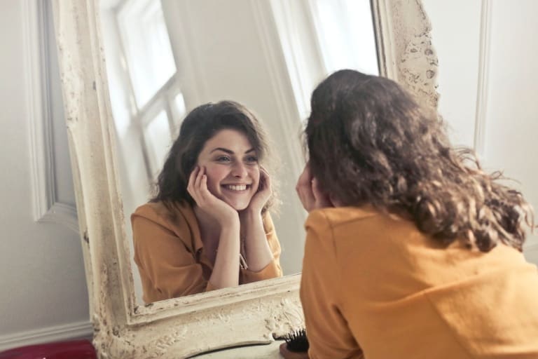 woman looking in the mirror
