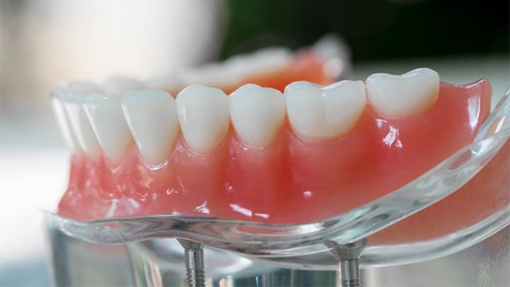 A set of lower dentures sitting on a clear base