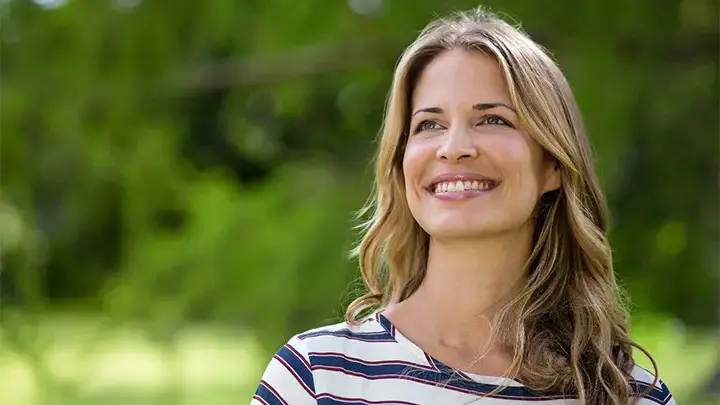 A beautiful woman smiling while looking into the distance