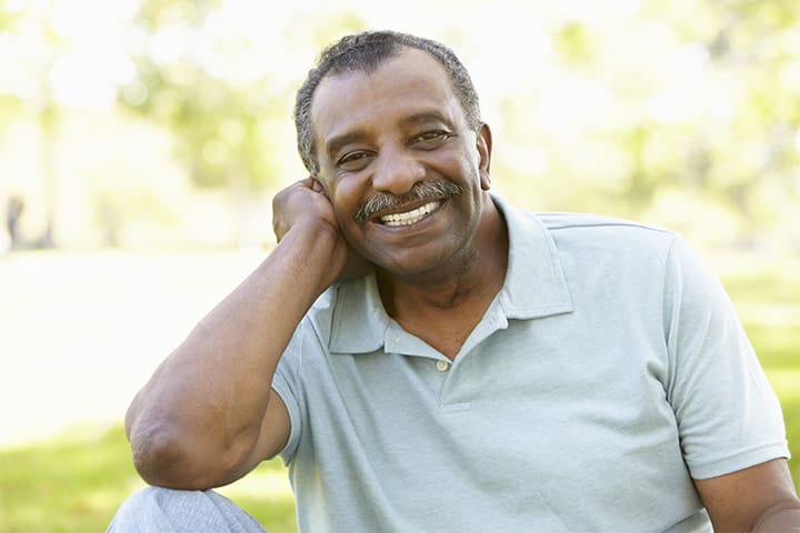 Man Smiling Outside After Getting Dental Implants
