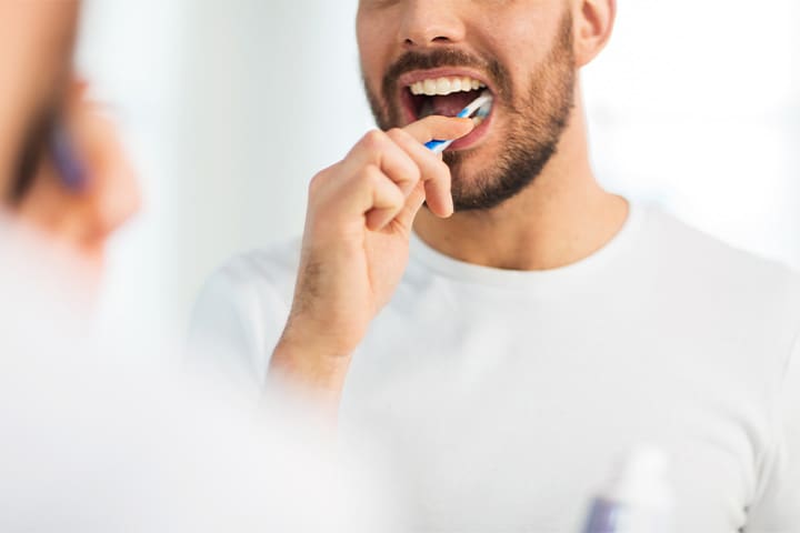 Closeup of man brushing his teeth