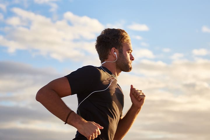 Person with headphones jogging outside