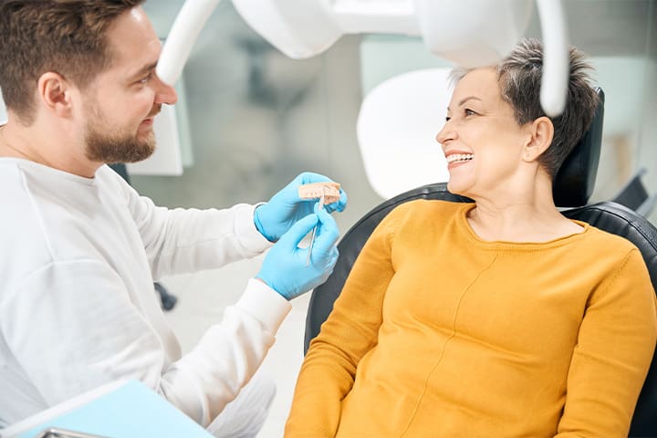 Dentist discussing the cost of dentures in Northampton
