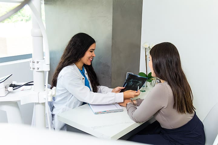 Dentist showing patient X-rays