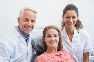 Woman smiling with a dental bridge in Northampton.