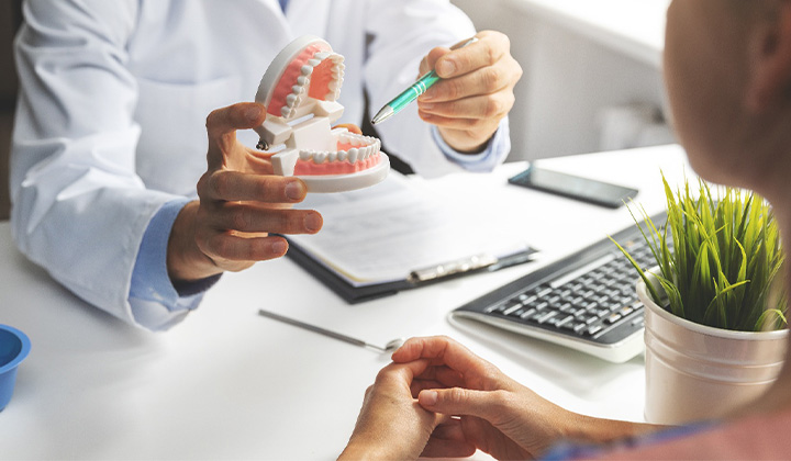 A patient consulting a dentist about All-on-X implants.