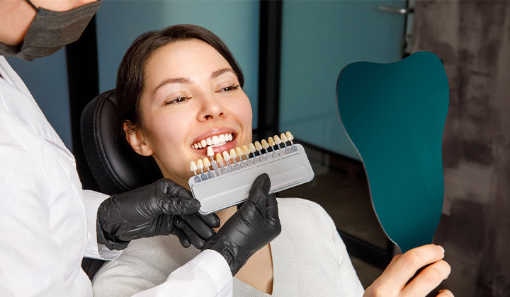 Female patient looking at her smile after learning the cost of teeth whitening in Northampton