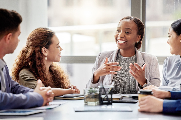 Woman smiling in a meeting.